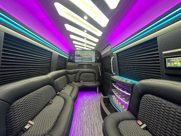 Scoop van interior with purple LED ambient lighting showing premium leather seating and modern entertainment system