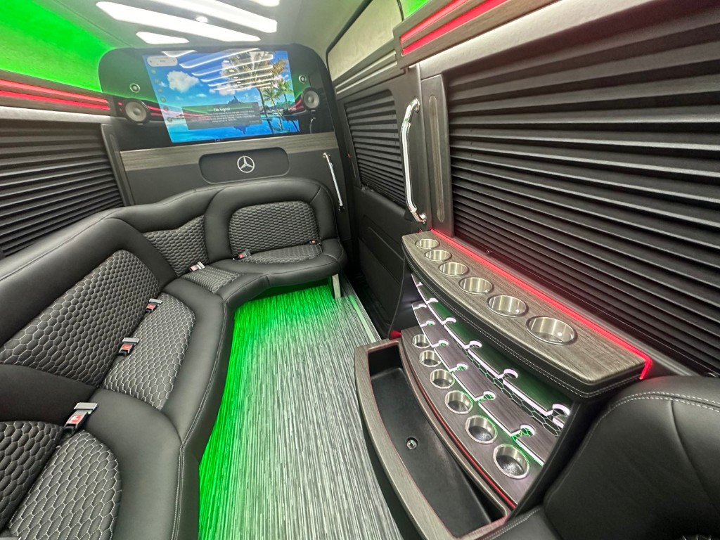 Scoop van interior with green LED lighting showing cup holders and entertainment display